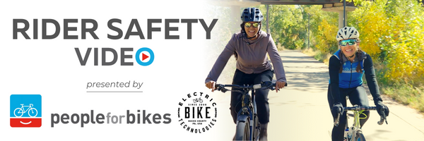 Two people riding bicycles, rider safety video powered by people for bikes