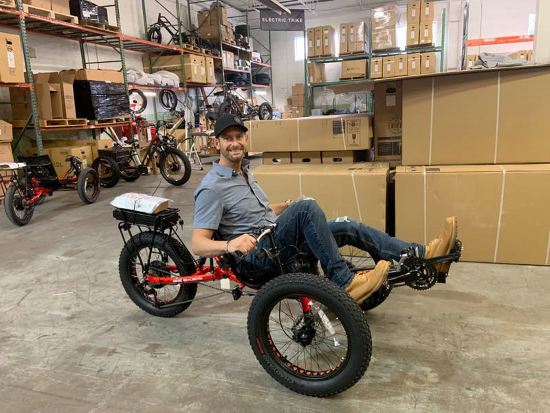 Jason Kraft, CEO of Electric Bike Technologies, sitting on an electric Fat-Tad trike.