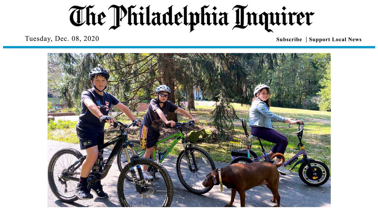 kids sitting on the bicycle and standing on the road with a dog, the philadelphia inquirer